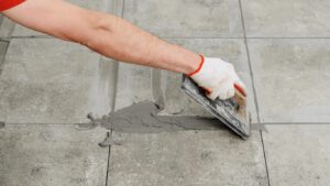 person grouting tile